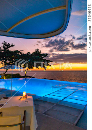 Sunset at the edge of a swimming pool at Kata beach in Phuket province, in Thailand Sunset at the edge of a swimming pool at Kata beach in Phuket province, in Thailand 85646458