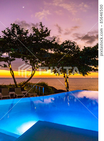Sunset at the edge of a swimming pool at Kata beach in Phuket province, in Thailand 85646500