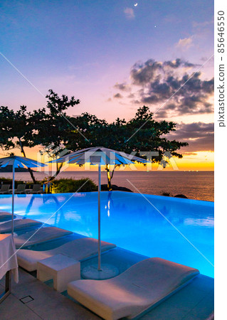Sunset at the edge of a swimming pool at Kata beach in Phuket province, in Thailand 85646550