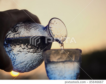 Sake blue glass sake bottle beautiful sunset back 85646667