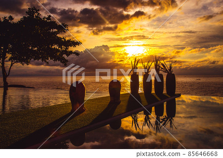 Sunset at the edge of a swimming pool at Kata beach in Phuket province, in Thailand 85646668