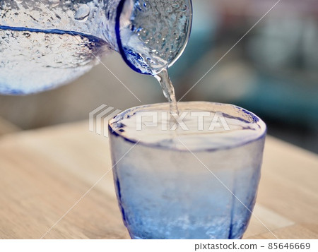 Sake blue glass sake bottle beautiful sunset back 85646669