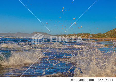 Surf on the beach with splashing water Surf on the beach with splashing water 85646744