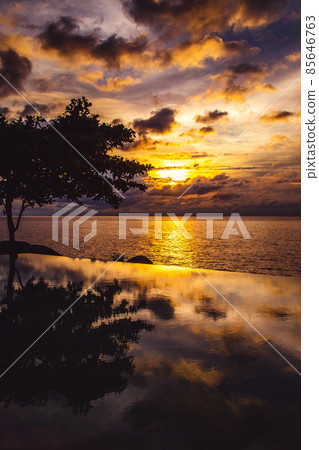 Sunset at the edge of a swimming pool at Kata beach in Phuket province, in Thailand 85646763