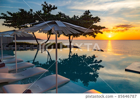 Sunset at the edge of a swimming pool at Kata beach in Phuket province, in Thailand Sunset at the edge of a swimming pool at Kata beach in Phuket province, in Thailand 85646787