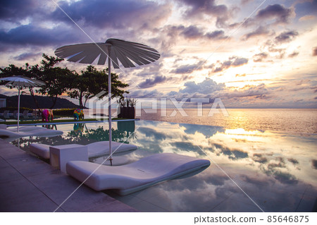 Sunset at the edge of a swimming pool at Kata beach in Phuket province, in Thailand Sunset at the edge of a swimming pool at Kata beach in Phuket province, in Thailand 85646875