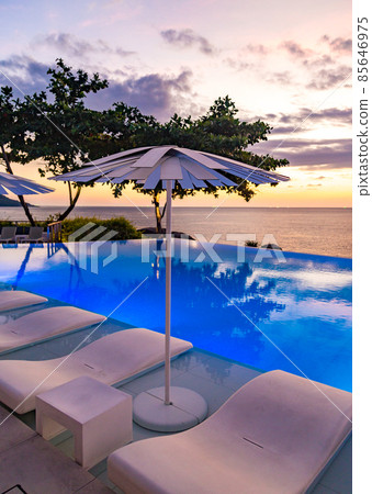 Sunset at the edge of a swimming pool at Kata beach in Phuket province, in Thailand 85646975