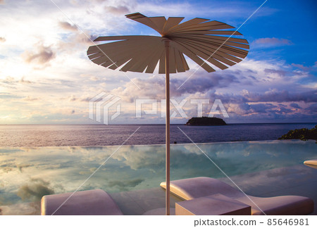 Sunset at the edge of a swimming pool at Kata beach in Phuket province, in Thailand 85646981