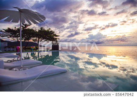Sunset at the edge of a swimming pool at Kata beach in Phuket province, in Thailand Sunset at the edge of a swimming pool at Kata beach in Phuket province, in Thailand 85647042