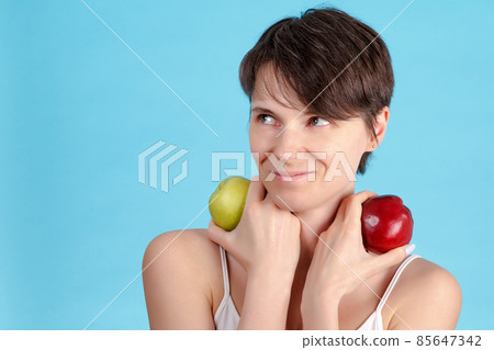 Portrait of beauty young beautiful sexy caucasian girl holding green and red apple food that made her strong and healthy 85647342