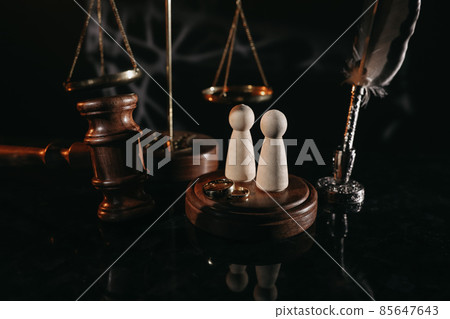 Law and Justice. Vertical image of judge gavel, wooden figures and wedding rings 85647643
