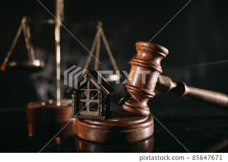 Concept of suing for property. Wooden gavel with house close-up Concept of suing for property. Wooden gavel with house close-up 85647671