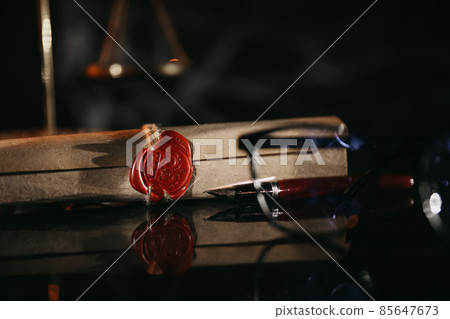 Document with wax seal, scales and antique stamp on a desk. Last will and legacy concept Document with wax seal, scales and antique stamp on a desk. Last will and legacy concept 85647673