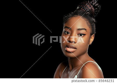 Adorable young african woman with well-kept skin isolated over dark studio background. Natural beauty concept. 85648231