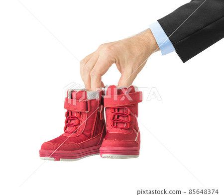 Hand with child shoes Hand with child shoes 85648374