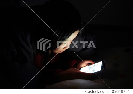 Children staying up late on their smartphones Children staying up late on their smartphones 85648765