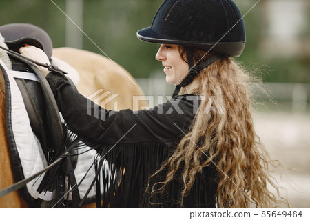 Portrait woman in black helmet with a horse 85649484