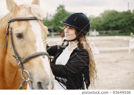 Portrait of riding horse with woman in black helmet Portrait of riding horse with woman in black helmet 85649506