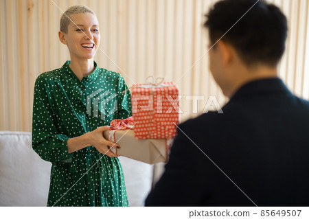 Asian man giving gift present to his girlfriend Asian man giving gift present to his girlfriend 85649507
