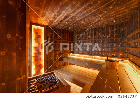 Empty wooden steam room with stone heater Empty wooden steam room with stone heater 85649737