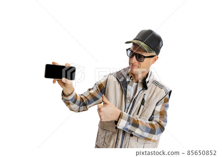 Portrait of young man wearing sport style clothes using phone isolated over white studio background Portrait of young man wearing sport style clothes using phone isolated over white studio background 85650852