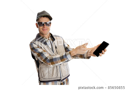 Portrait of young man wearing sport style clothes using phone isolated over white studio background Portrait of young man wearing sport style clothes using phone isolated over white studio background 85650855