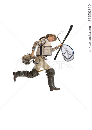 Portrait of young man, professional fisherman with fishing rod, spinning and equipment going to river isolated over white studio background Portrait of young man, professional fisherman with fishing rod, spinning and equipment going to river isolated over white studio background 85650860