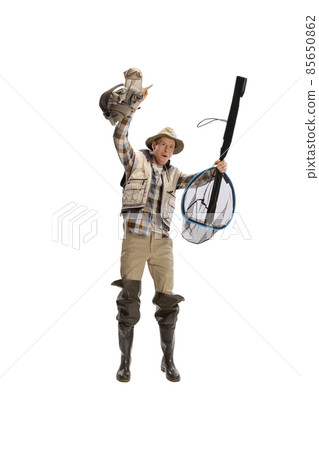 Portrait of young man, professional fisherman with fishing rod, spinning and equipment going to river isolated over white studio background Portrait of young man, professional fisherman with fishing rod, spinning and equipment going to river isolated over white studio background 85650862