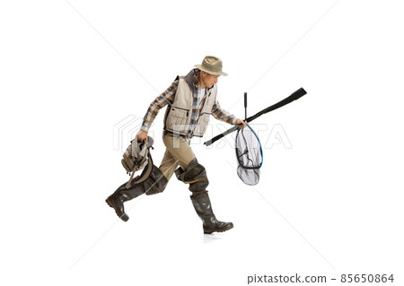 Portrait of young man, professional fisherman with fishing rod, spinning and equipment going to river isolated over white studio background Portrait of young man, professional fisherman with fishing rod, spinning and equipment going to river isolated over white studio background 85650864