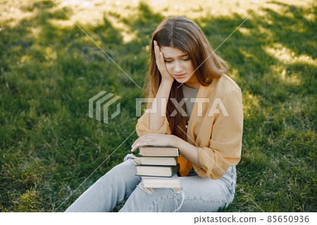 Upset thoughtful female student sit in a park looking disapointed and sad Upset thoughtful female student sit in a park looking disapointed and sad 85650936