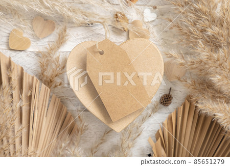 Heart shaped Valentines present with blank gift tag, pampas grass and hearts, boho Mockup Heart shaped Valentines present with blank gift tag, pampas grass and hearts, boho Mockup 85651279