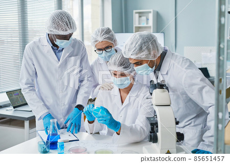 Scientists examining sample in team 85651457