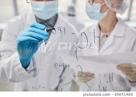 Scientists working with formulas in team Scientists working with formulas in team 85651469