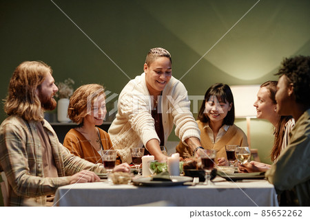 Woman meeting with friends at dinner party Woman meeting with friends at dinner party 85652262