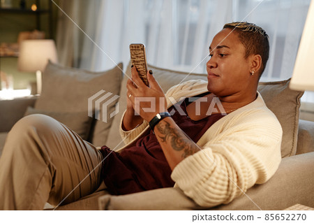 Woman using phone at home 85652270