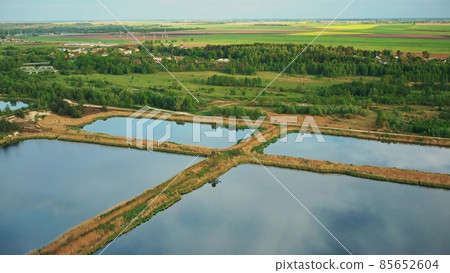 Aerial View Retention Basins, Wet Pond, Wet Detention Basin Or Stormwater Management Pond, Is An Artificial Pond With Vegetation Around The Perimeter, And Includes A Permanent Pool Of Water In Its 85652604