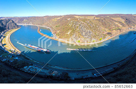 Panoramic drone image of the Loreley rock on the Rhine river taken from the opposite side of the Rhine under blue sky and sunshine 85652663