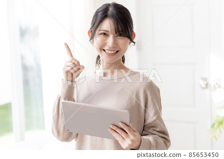 Female using a tablet Female using a tablet 85653450