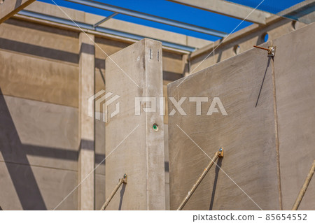 Construction site with precast concrete columns, beams and walls Construction site with precast concrete columns, beams and walls 85654552