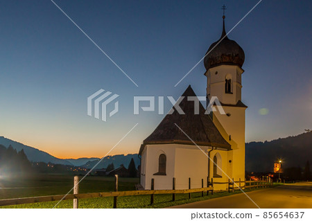 Typical small church in Austrian village Tannheim in Tyrol during dusk Typical small church in Austrian village Tannheim in Tyrol during dusk 85654637