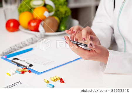Nutritionist prepares a diet plan for an overweight woman Nutritionist prepares a diet plan for an overweight woman 85655348