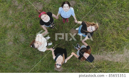 Girls friends look at the top holding hands. 85655351