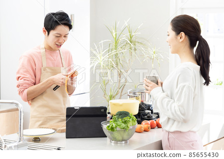 Adult man enjoying home time in the kitchen Adult man enjoying home time in the kitchen 85655430