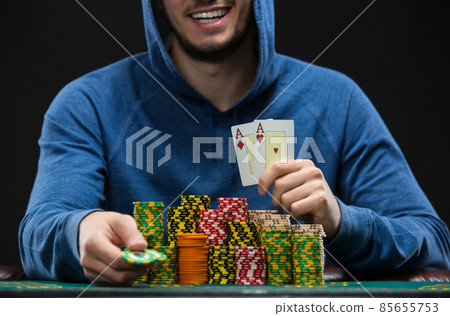 Poker player showing a pair of aces. Closeup 85655753