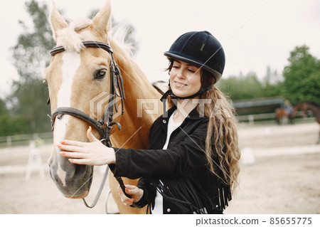 Portrait of riding horse with woman in black helmet 85655775