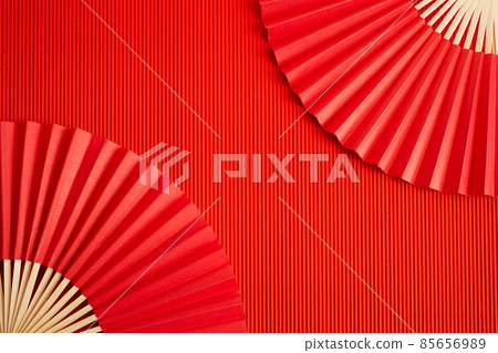 Chinese new year. Red abstract background with hand paper fan for product presentation. 85656989