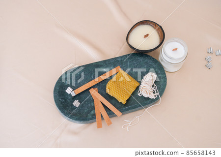Close-up high-angle view of components for production of aromatic spa soy handmade candles on light background. 85658143