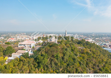 Aerial top view of Phra Nakhon Khiri Historical Park or Khao Wang, Phetchaburi urban city town with forest trees and green mountain hills. Nature landscape background, Thailand. Aerial top view of Phra Nakhon Khiri Historical Park or Khao Wang, Phetchaburi urban city town with forest trees and green mountain hills. Nature landscape background, Thailand. 85658661