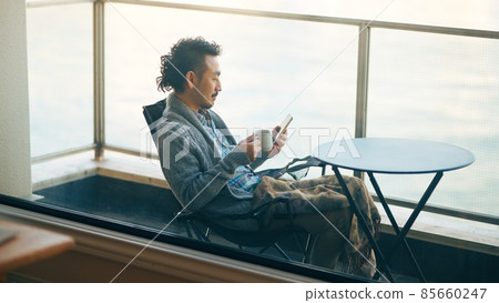 Bearded man working remotely on the balcony 85660247