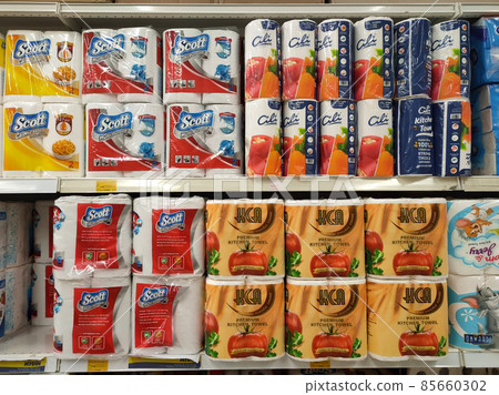 PENANG, MALAYSIA -JANUARY 2, 2022: Selective focused on bathroom tissue & kitchen towel on display for sale in a supermarket. Sorted by brand and labeled with a price tag. 85660302